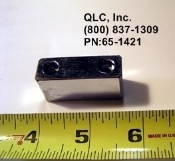 A metal object is shown next to a ruler.